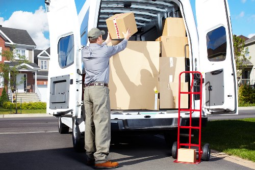 Professional movers carrying furniture through a narrow staircase