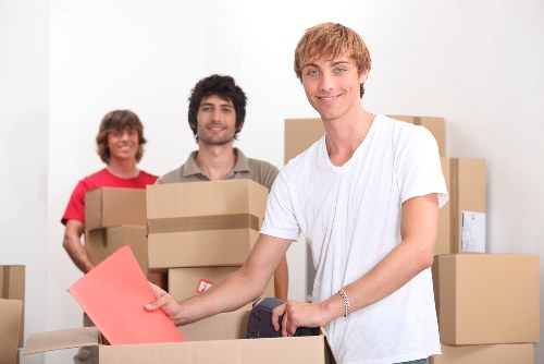 Mover wearing PPE while handling household items safely