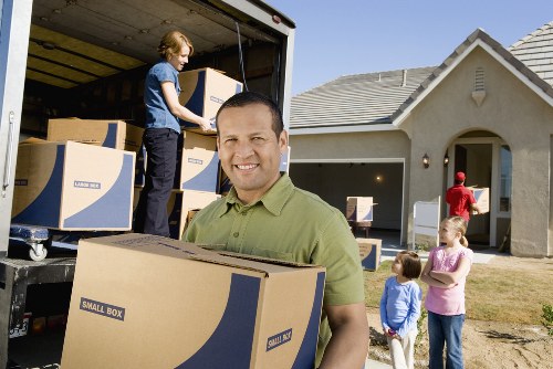 Movers transporting office items through a Haringey business premises