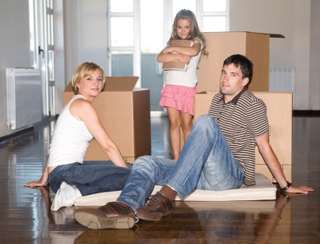 Local movers loading boxes and furniture into a van