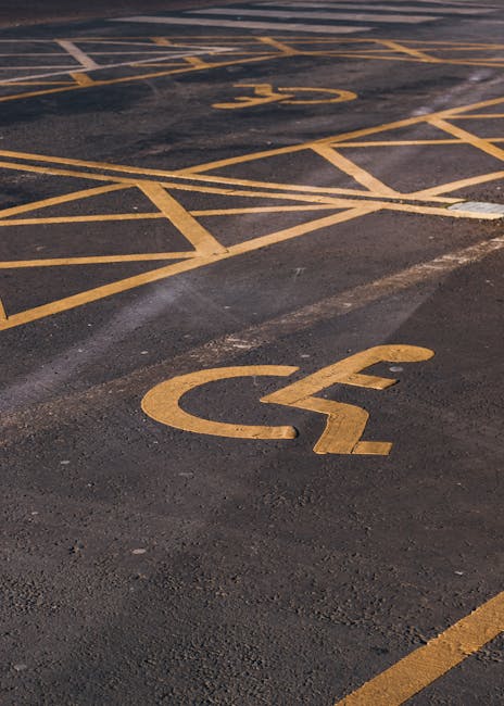 Close-up of a round 'no parking' sign with a red border and diagonal line crossing out the black letter 'P' on a light grey background, mounted on a metal pole. The image is taken outdoors under an overcast sky. This type of signage is important for indicating restricted parking areas in residential zones, often relevant for house removals and furniture transport during home relocation or moving services, as provided by Haringey Man and Van. Proper understanding of parking restrictions can facilitate efficient loading and unloading processes for professional removals teams, helping to comply with local council rules for parking permits in Haringey. The sign's clear visibility ensures drivers and movers are aware of no-parking zones, aiding in planning the logistics of household moves while minimizing delays and parking violations.